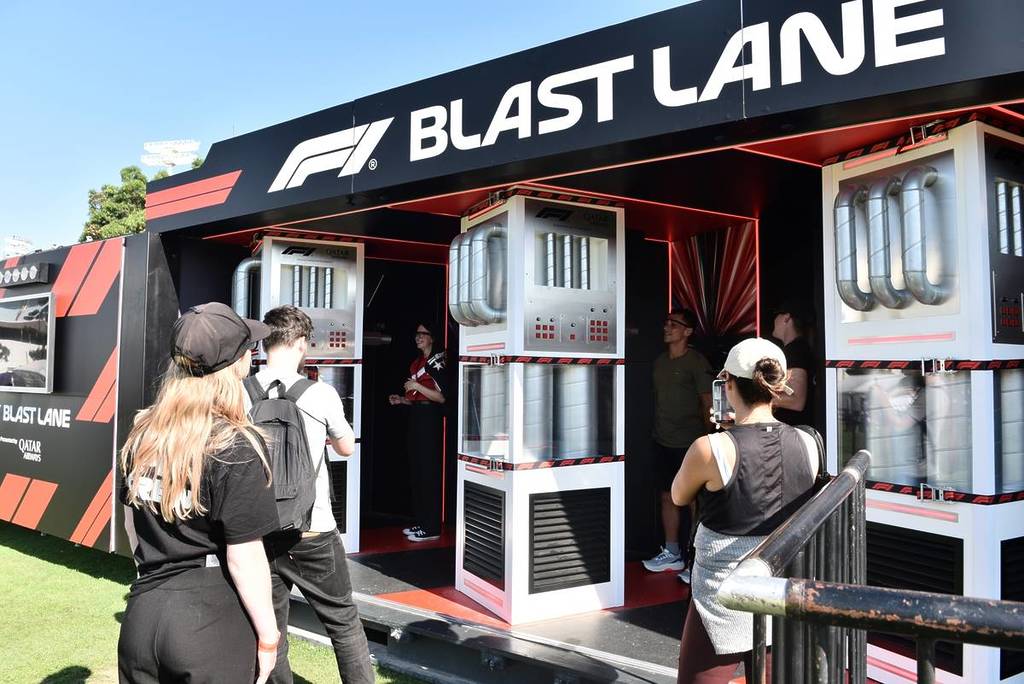 people entering a car activation that says 'Blast Lane' at the F1 Melbourne Fan Festival