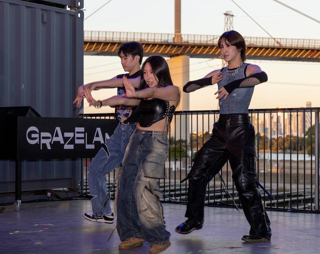 kpop dancers performing at the Victorian Multicultural Festival in Grazeland, with West Gate Bridge in the background