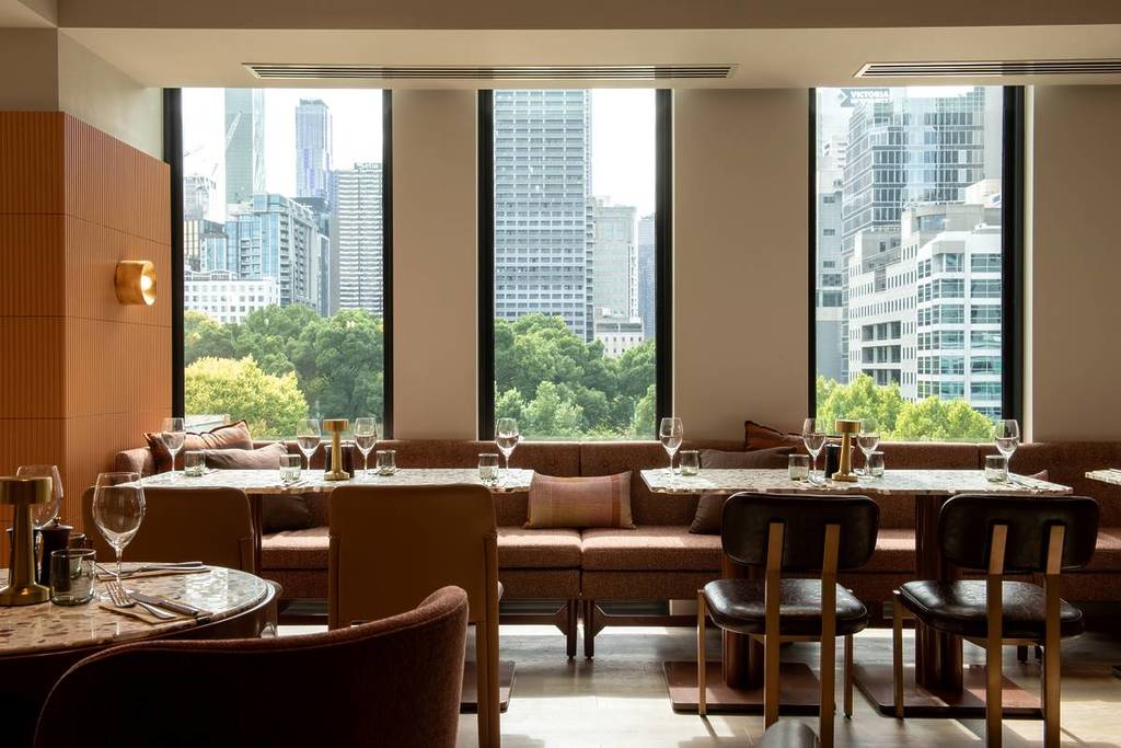 inside the restaurant Foundry, with glimpses of the city and garden seen through the windows
