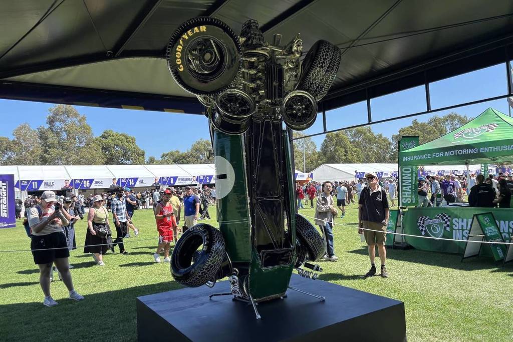 an inflatable 1960s car balancing on its front
