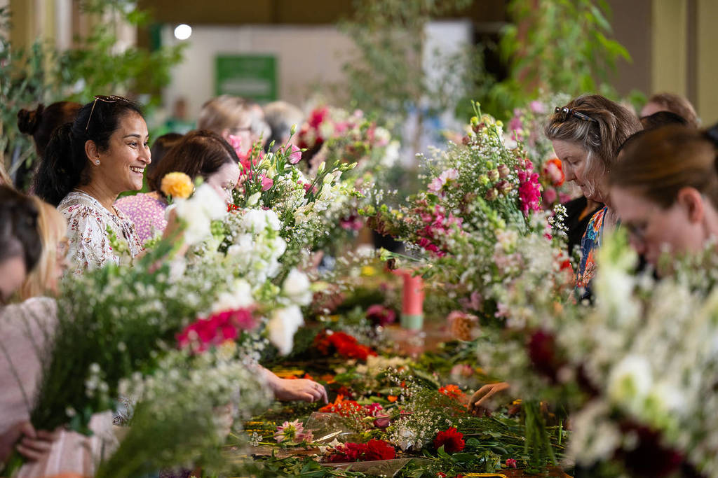 people taking part in a flower arranging workshop