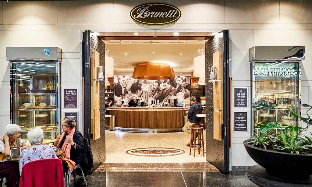 exterior shot of Brunetti Classico, with customers outside and doors open to reveal counters inside