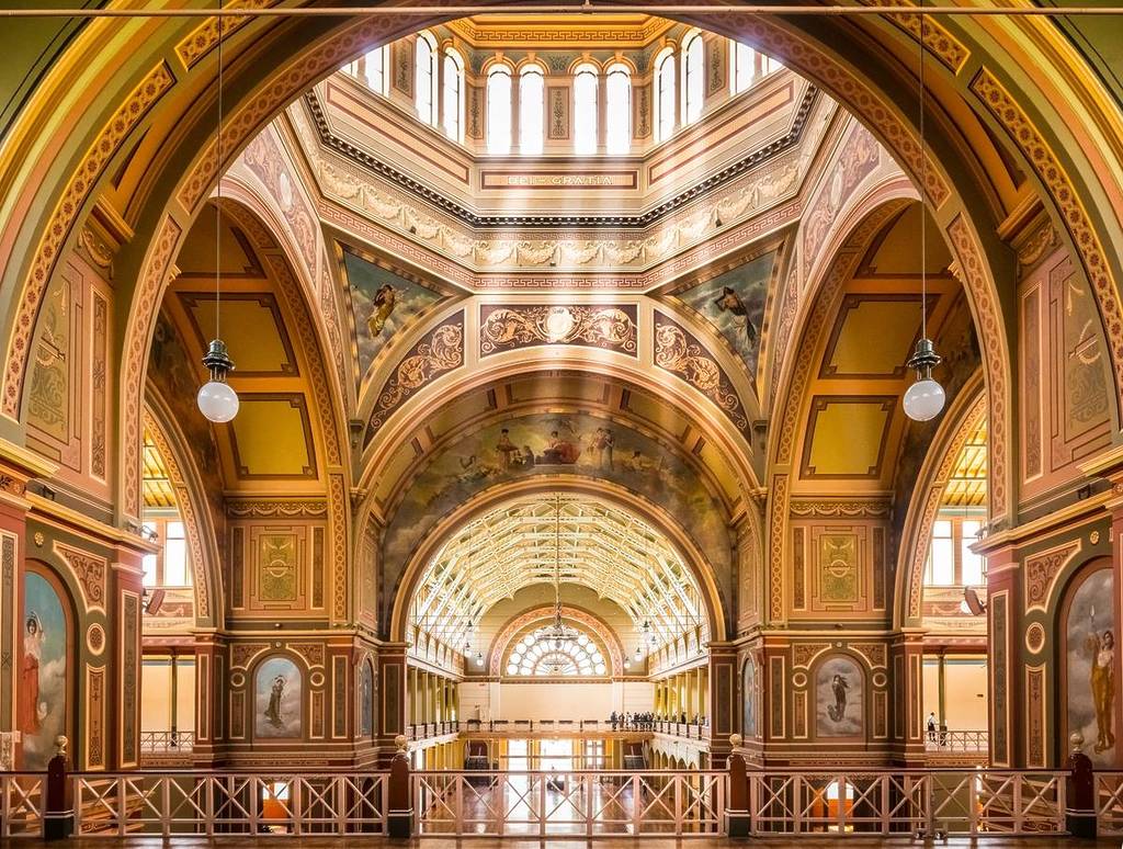 inside the Royal Exhibition Building on a sunny day, so the space is filled with golden light