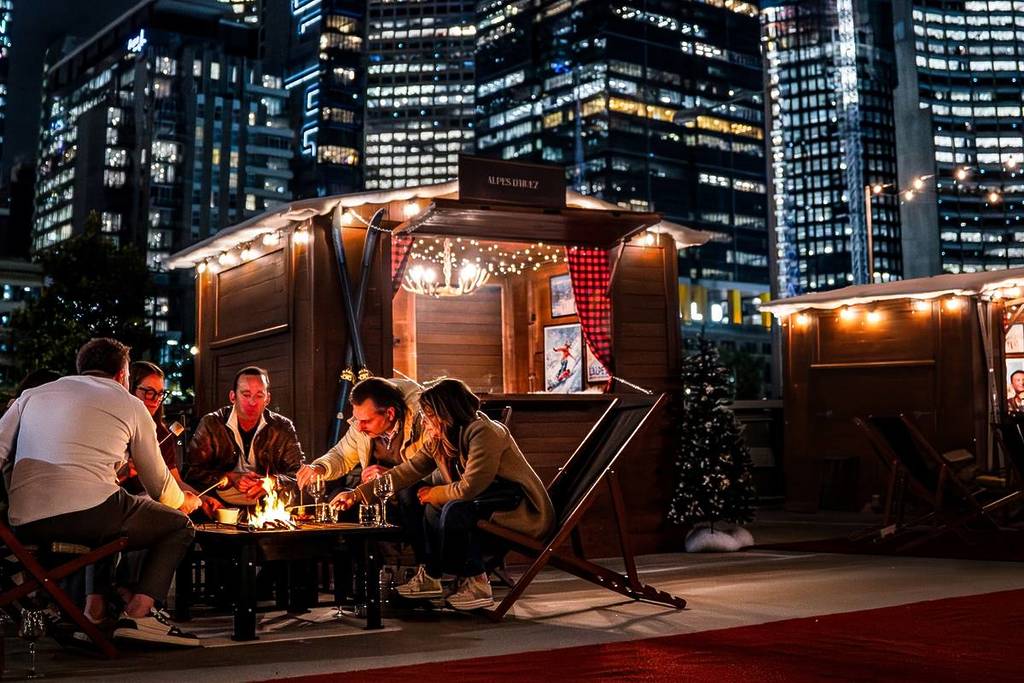 people by a fire pit at Fondue Chalet