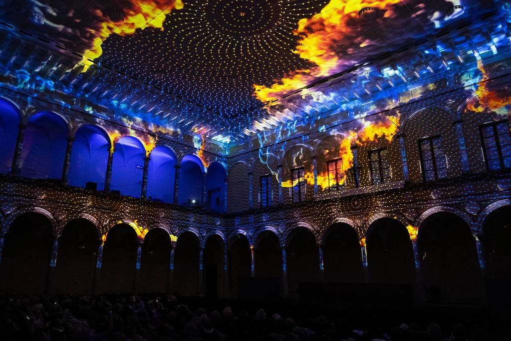 Imagery of clouds and patterns projected along walls and ceilings