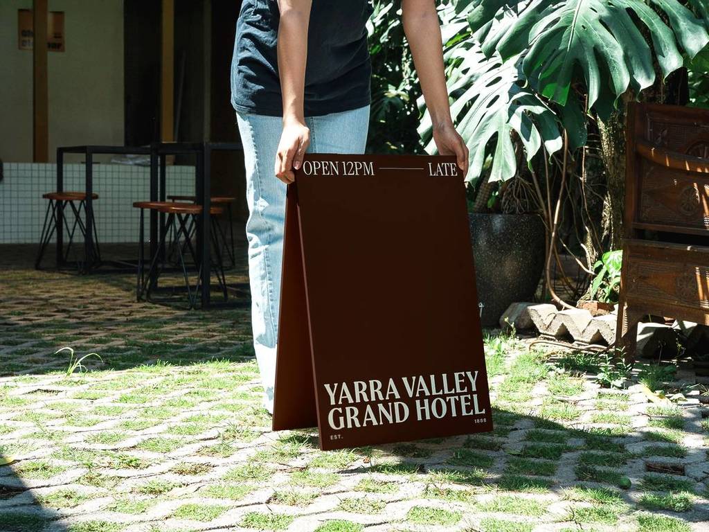 someone putting out the front sign for Yarra Valley Grand Hotel