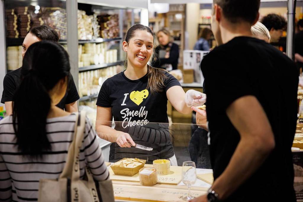 someone giving out cheese at Good Food & Wine Show