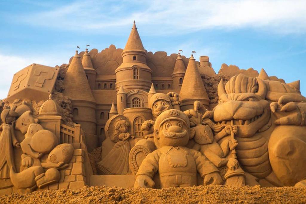characters from Super Mario carved out of sand