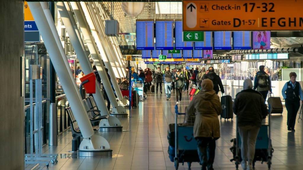 people moving around an airport in Amsterdam
