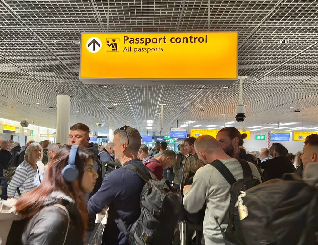 crowd waiting to clear passport control at an airport in Amsterdam