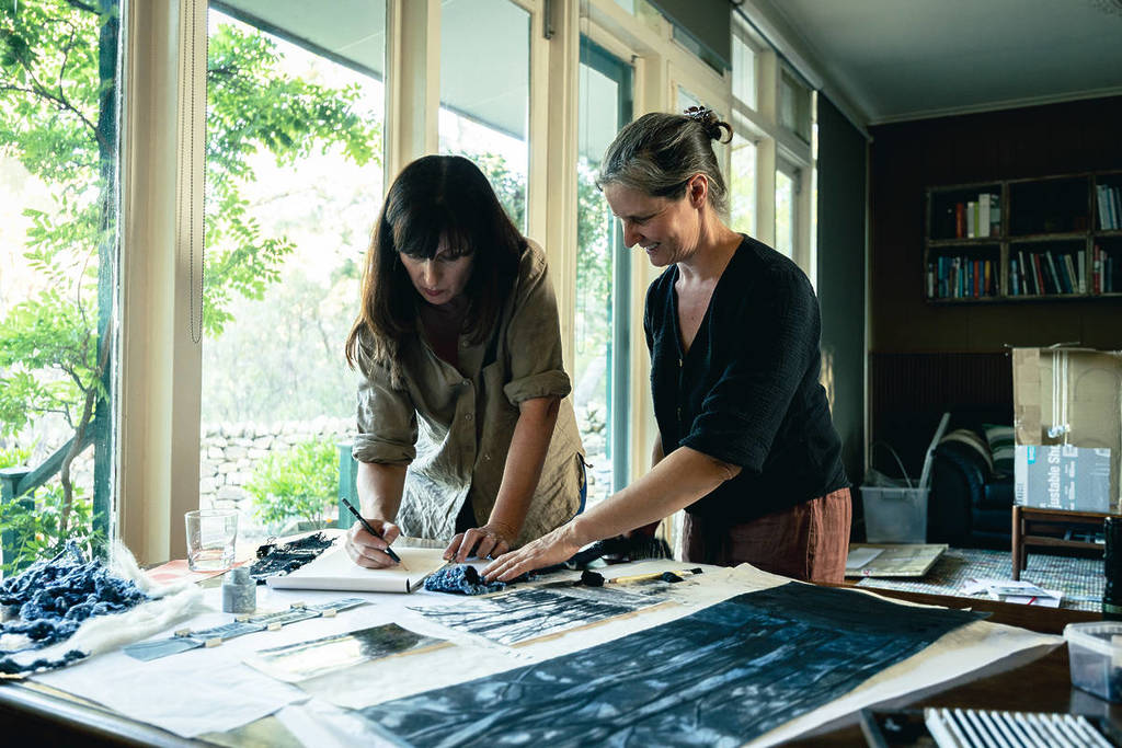 two female artists looking over textiles for Ballarat Craft and Design Week