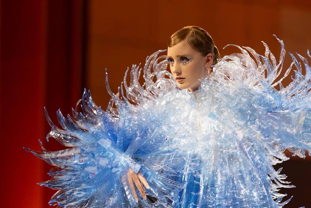 model wearing a shiny blue costume