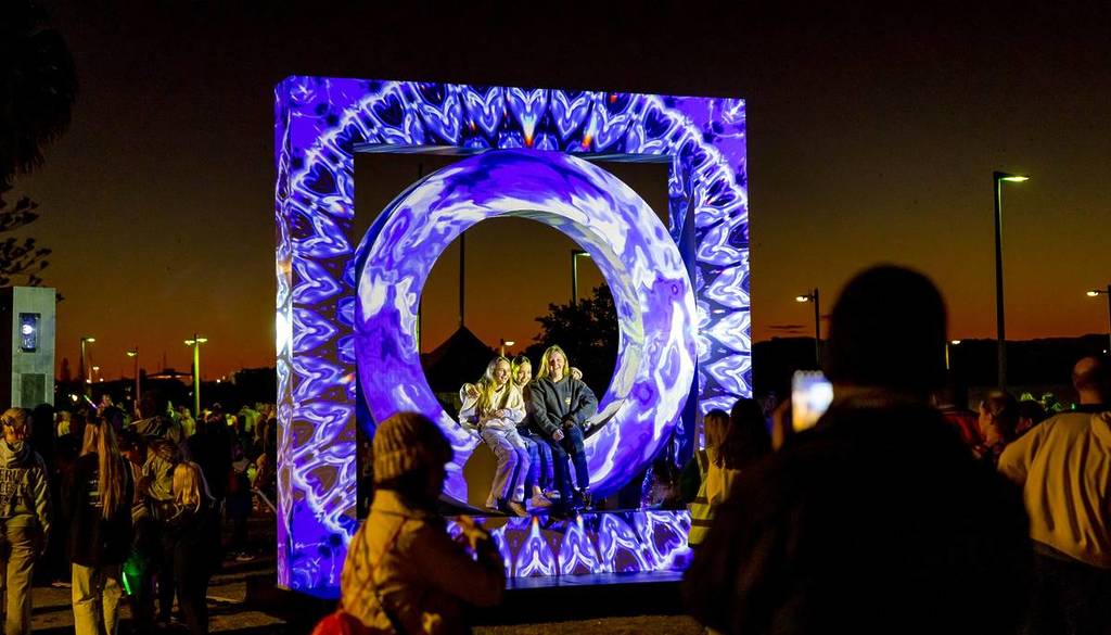 people sitting on the Stargate installation by Neon Fields