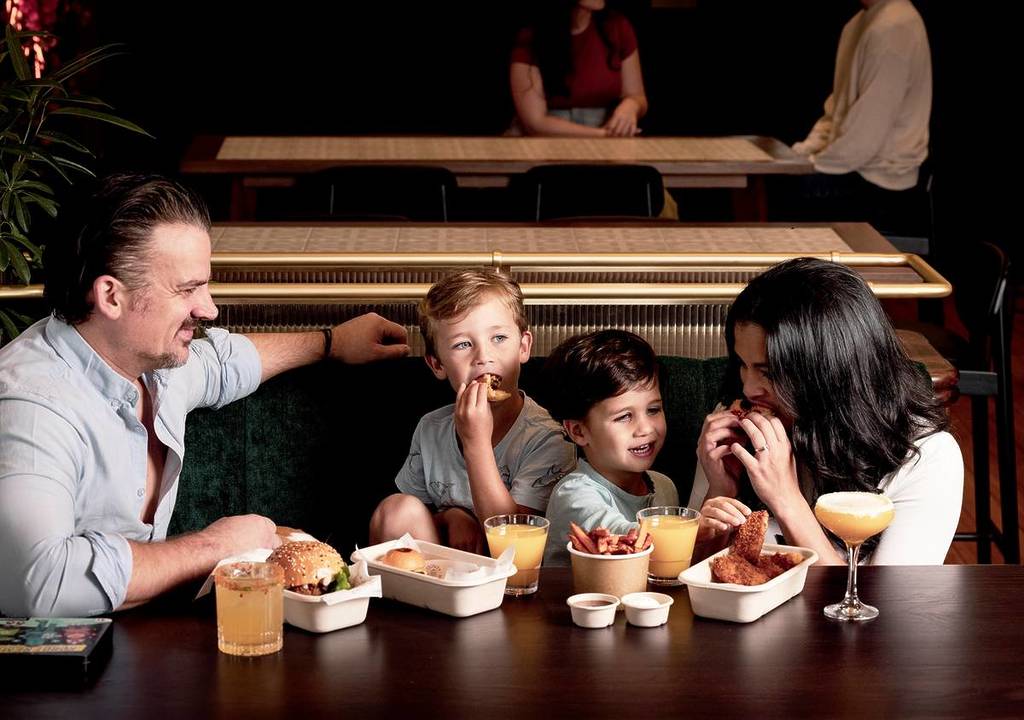 family eating burgers at Trinity in St Kilda