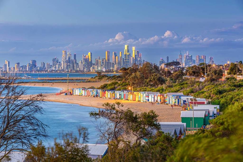 Brighton Bathing Boxes, with Melbourne skyline in the background