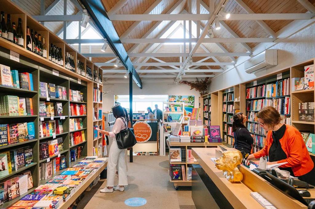 people browsing through Antipodes Bookshop in Sorrento while staff member is at the counter