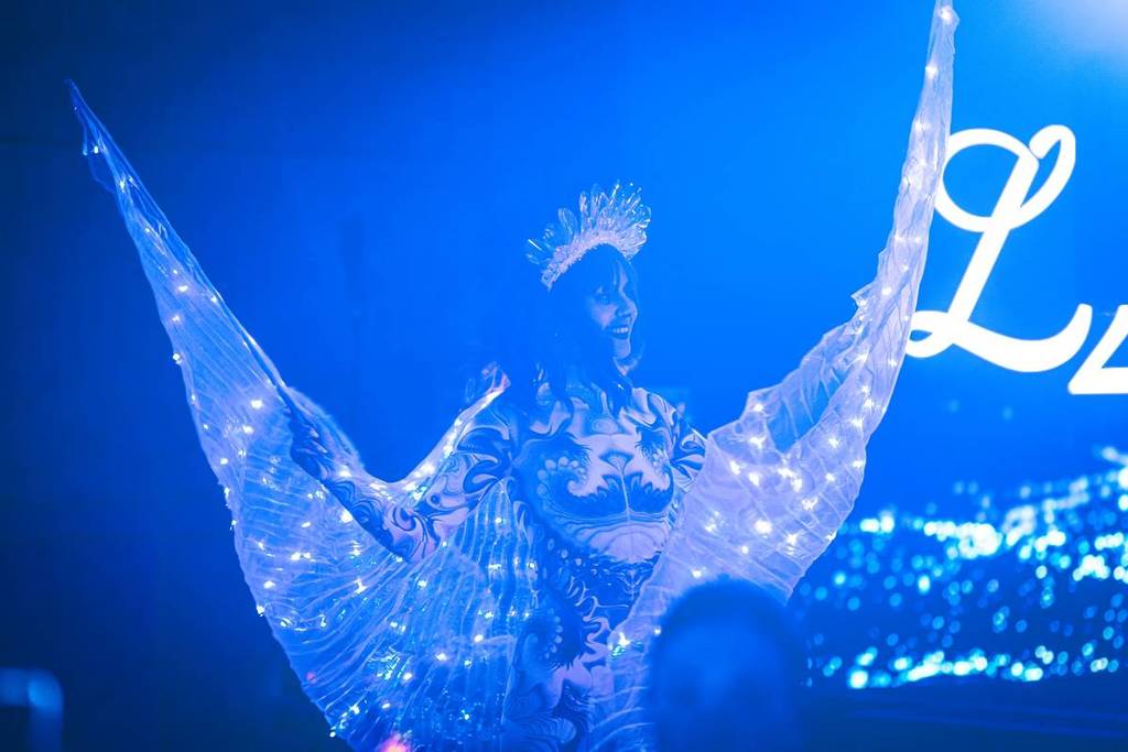 roaming performer with LED wings at Sorrento Solstice Festival