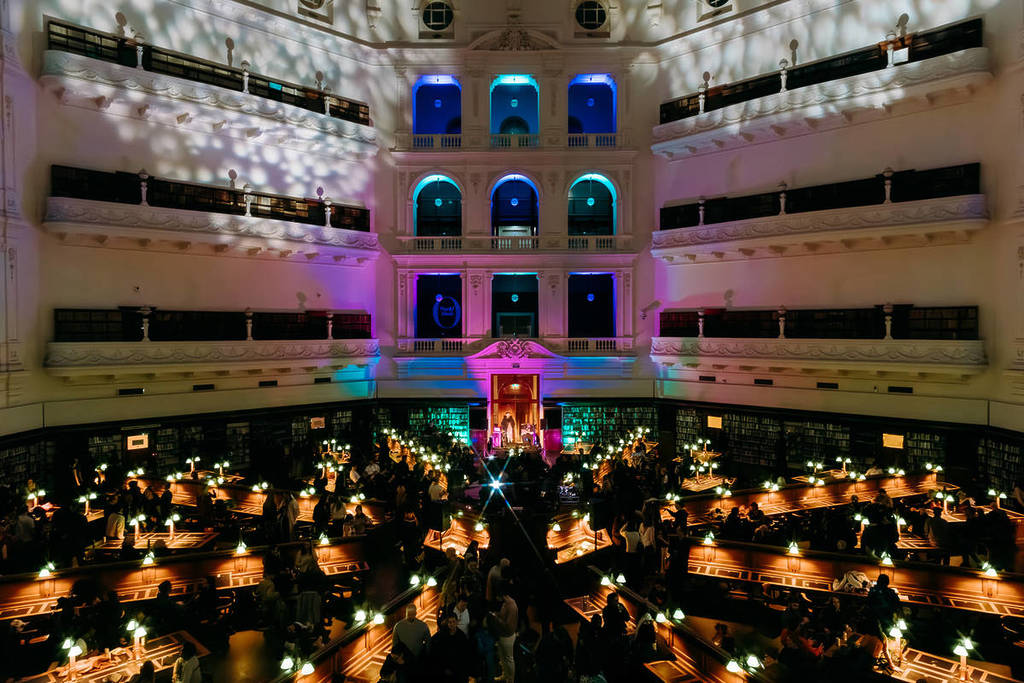 Inside State Library Victoria at night, with projections on the walls