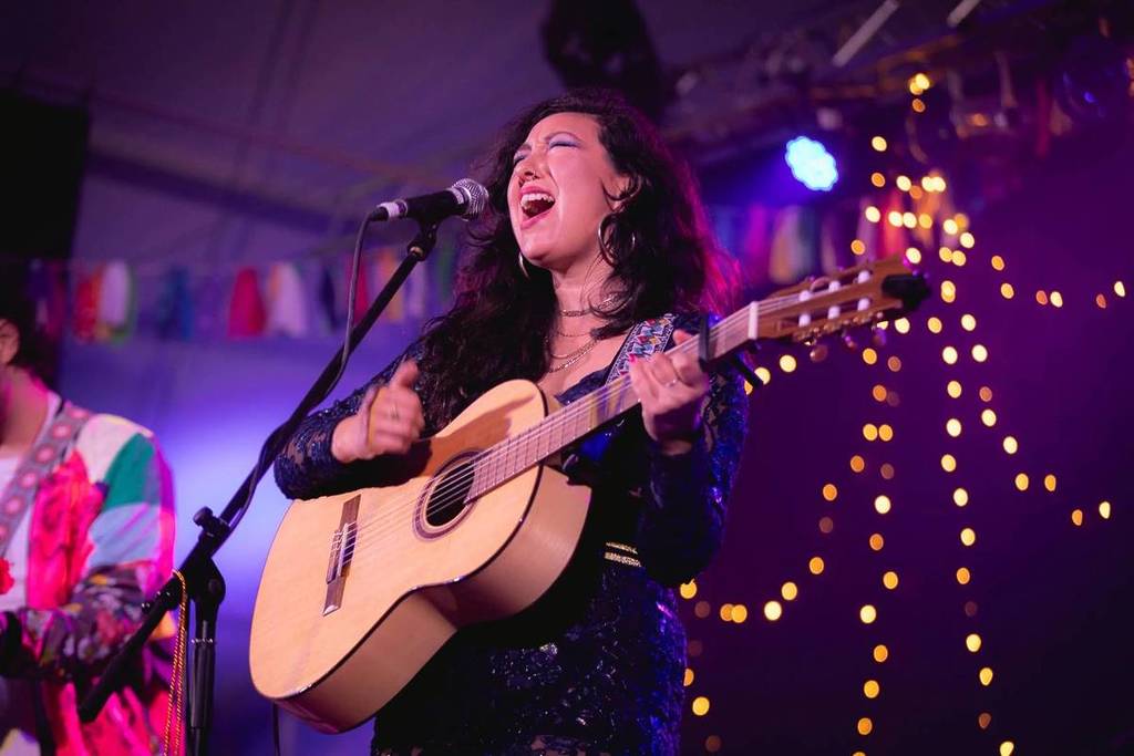 musician singing and playing guitar