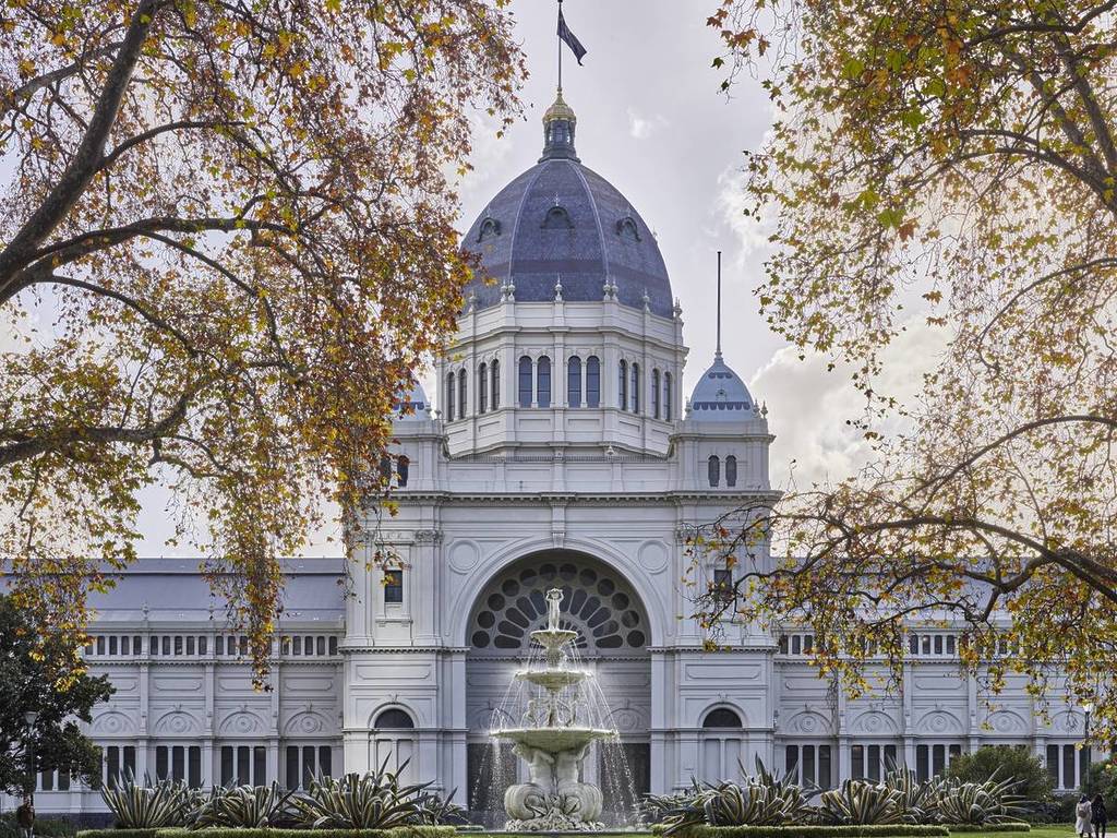 the Royal Exhibition Building and fountain framed by autumn leaves