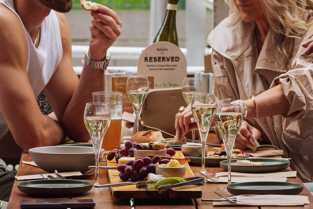 dining table at Yarra Botanica with glasses of champagne and a grazing board