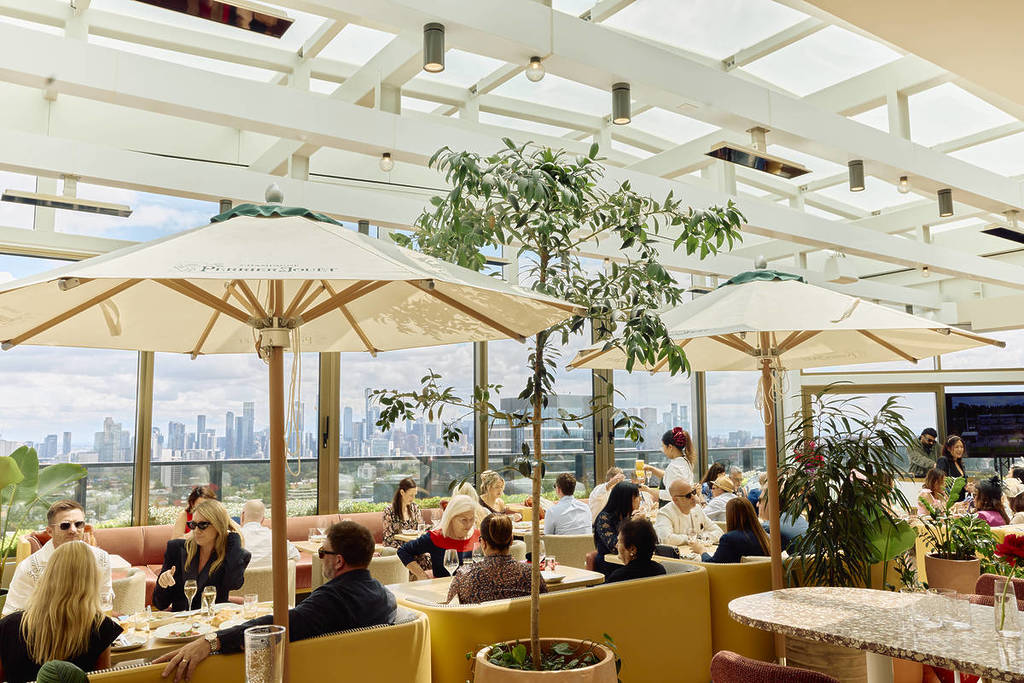 people dining at Beverly, with view of Melbourne skyline in the background