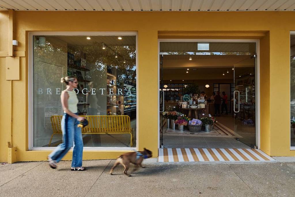 woman walking her dog outside of Breadcetera in Mount Eliza