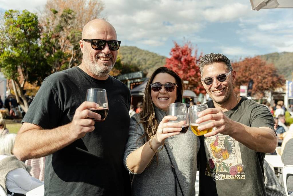 three people showing their wine glasses at La Fiera Italian Festival