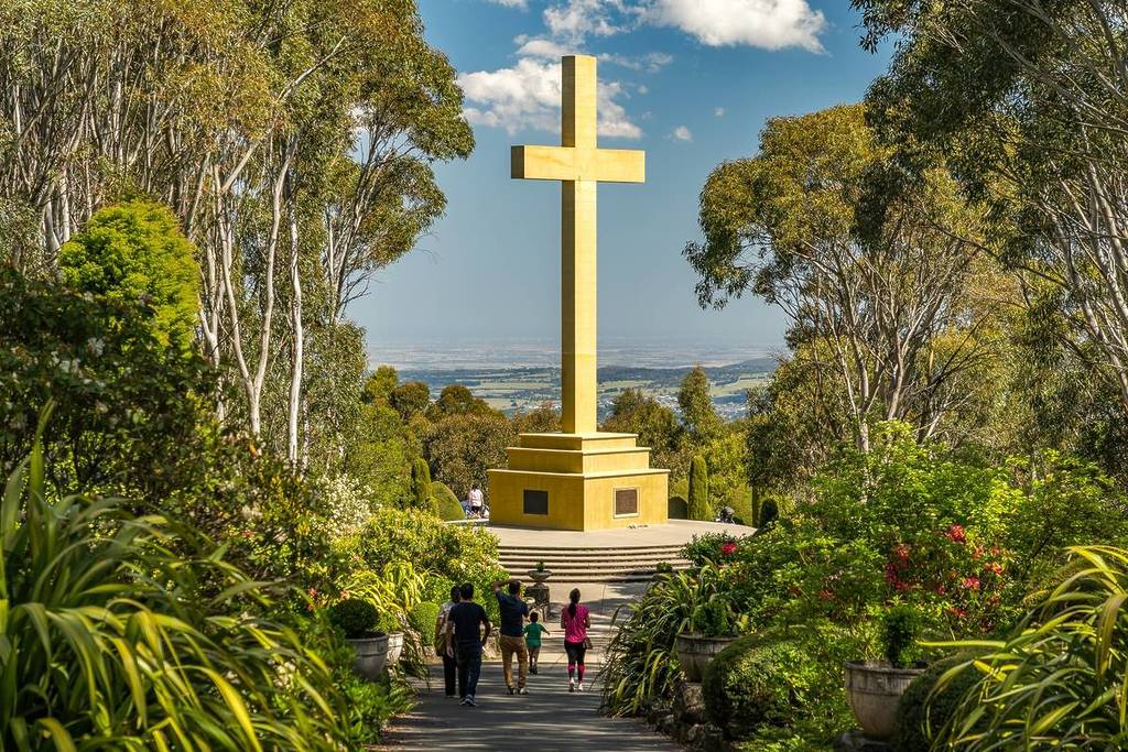 visitors to Mount Macedon Memorial Cross on a sunny day
