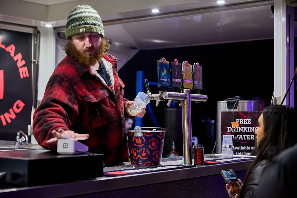 bartender processing a drink payment