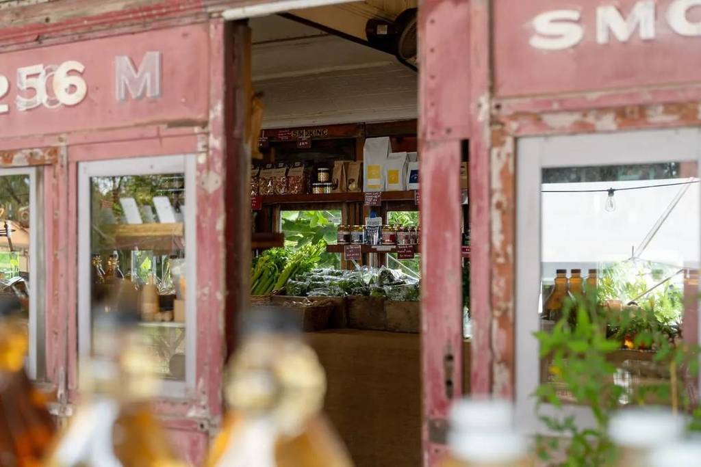 looking through the doors into the shop in the red rattler train carriage on Benton Rise Farm