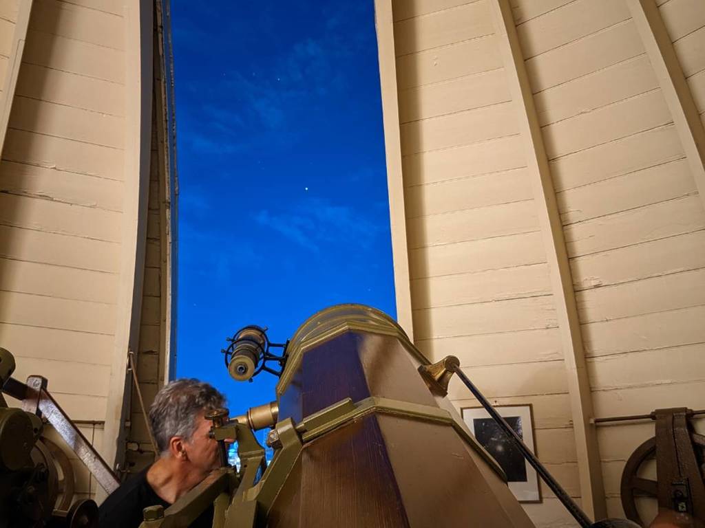 man looking through telescope at Melbourne Observatory at part of Stellar Nights tour