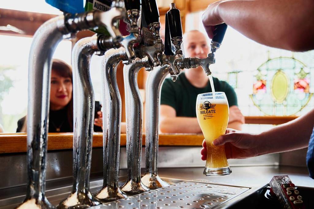 someone pouring a beer for a customer at Holgate Brewhouse in Woodend