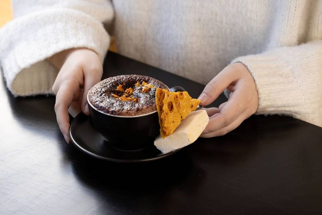 woman holding hot chocolate from La Miette Patisserie in Ballarat