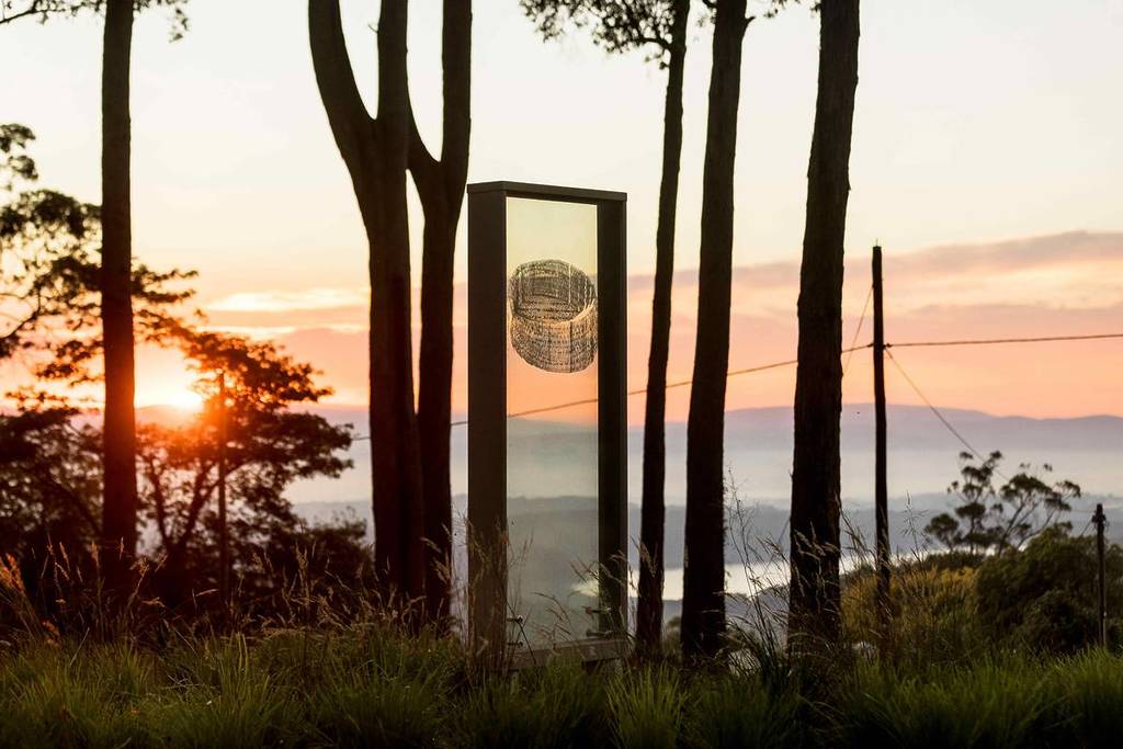 glass installation called djirra binak in the forest at sunset, one of the art pieces you can see on the ngurrak barring trails in the Dandenong Ranges
