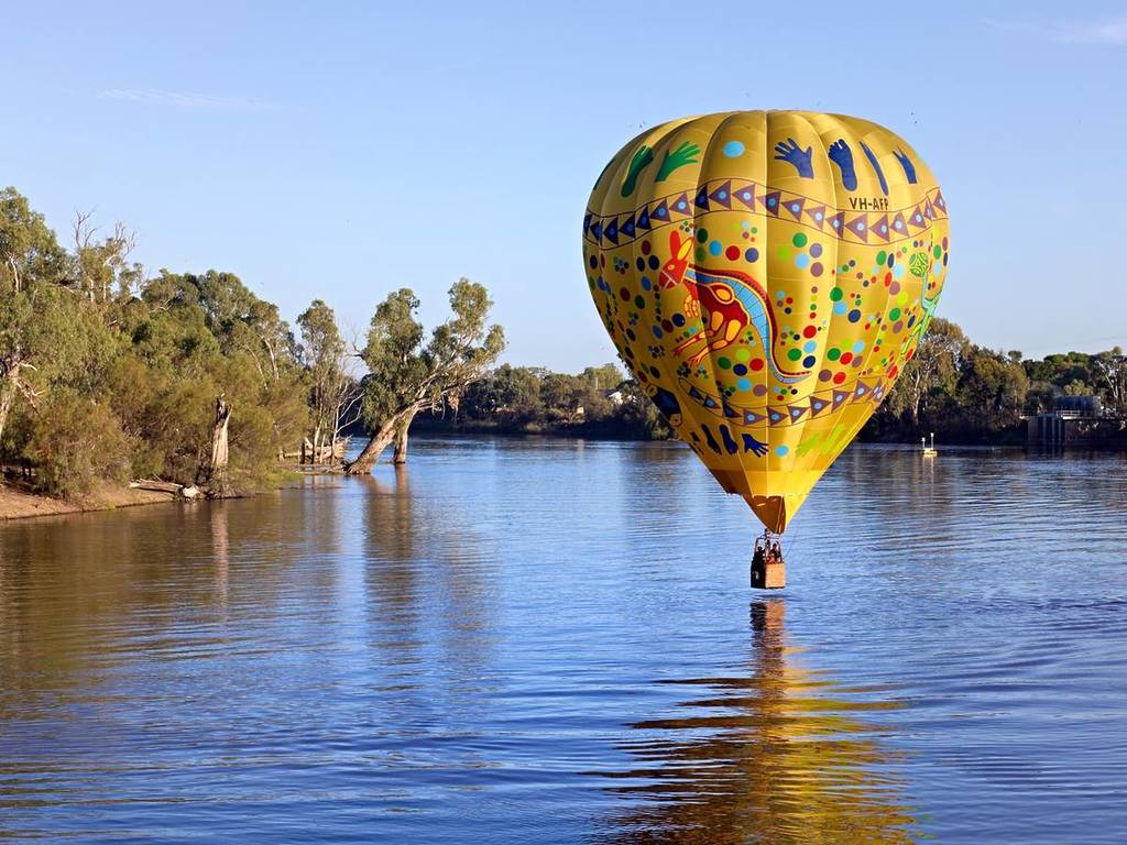 a hot air balloon floating just above the Murray River