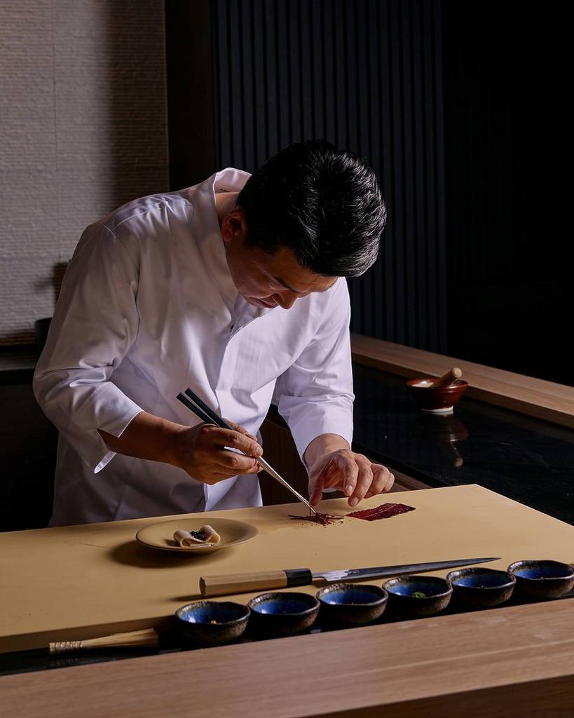 owner chef Jun Park preparing dishes for diners