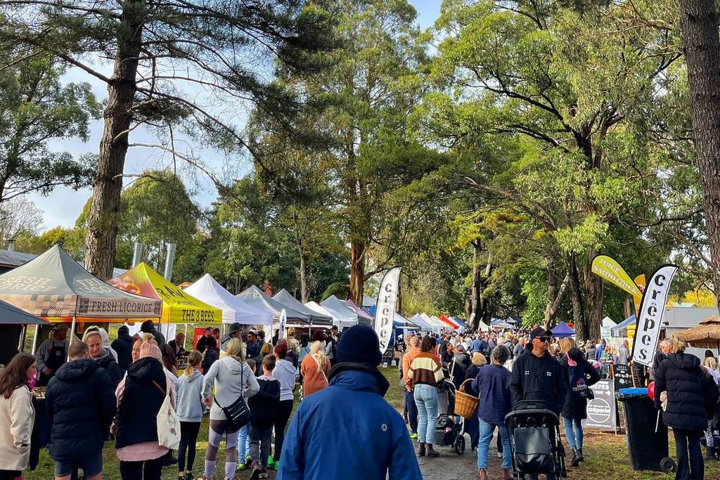people walking among the stalls at The Lost Woods Market