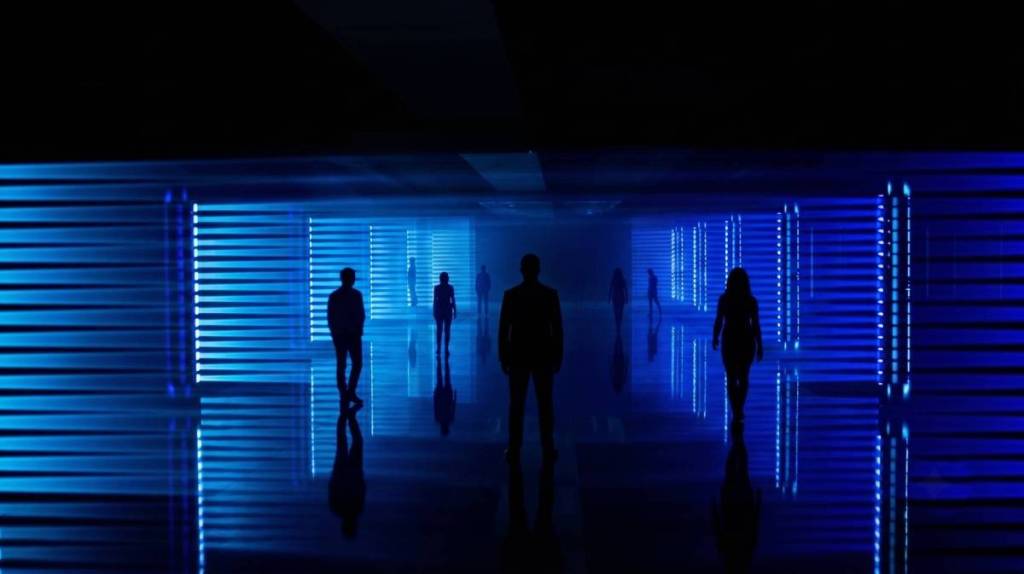 people surrounded by blue light in a dark room in Converge
