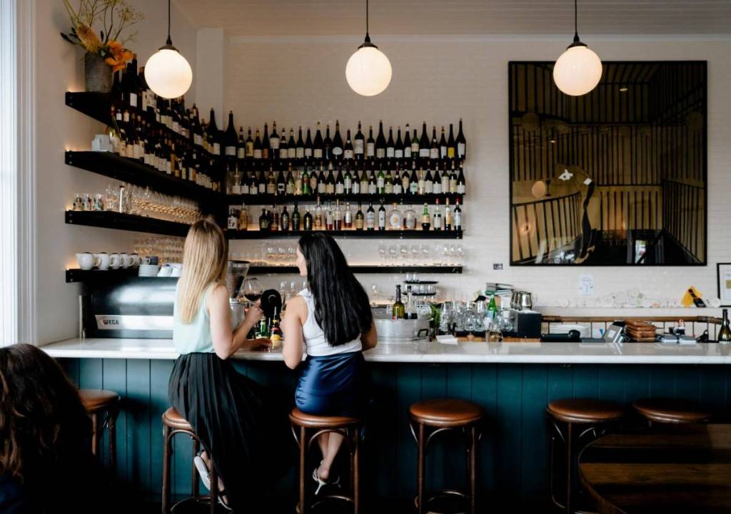 two women seated at the bar area in Carlton Wine Room