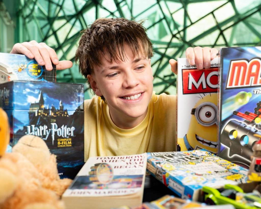 boy posing with different boardgames
