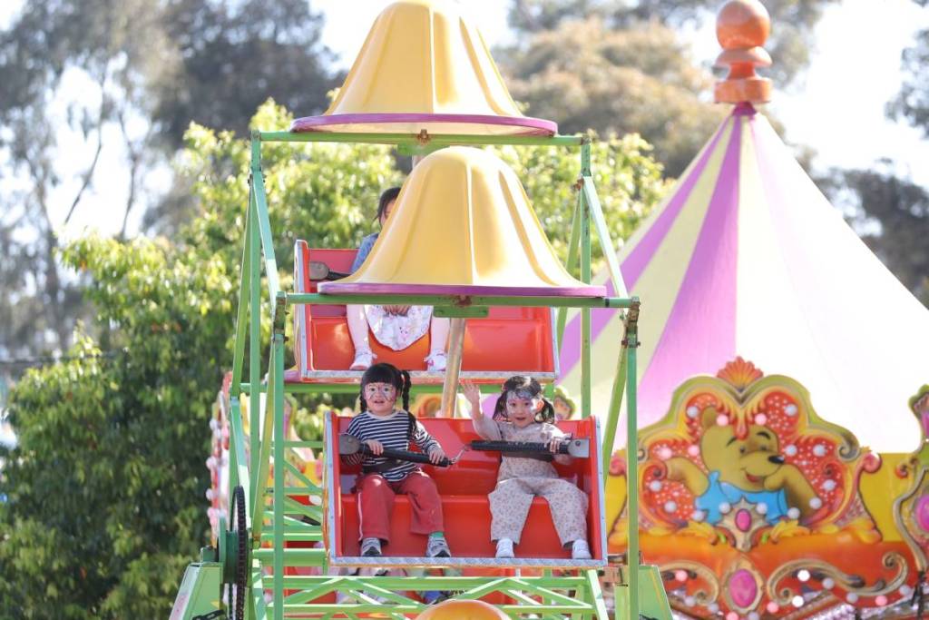 two children on a little Ferris wheel at Melbourne Royal Show