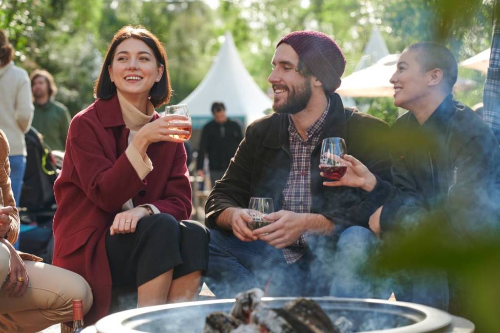 people sipping wine around a bonfire at Wine & Wildlife in Healesville Sanctuary