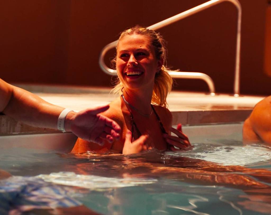 woman laughing in pool at Wellness Social Club