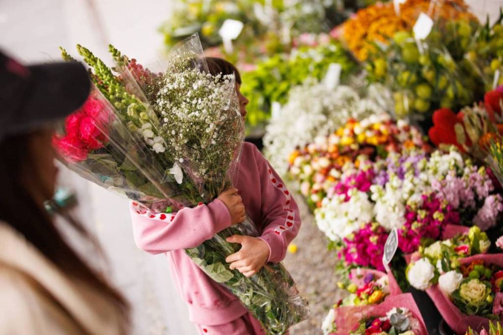 child picking flowers at the Docklands Waterfront Farmers’ Market