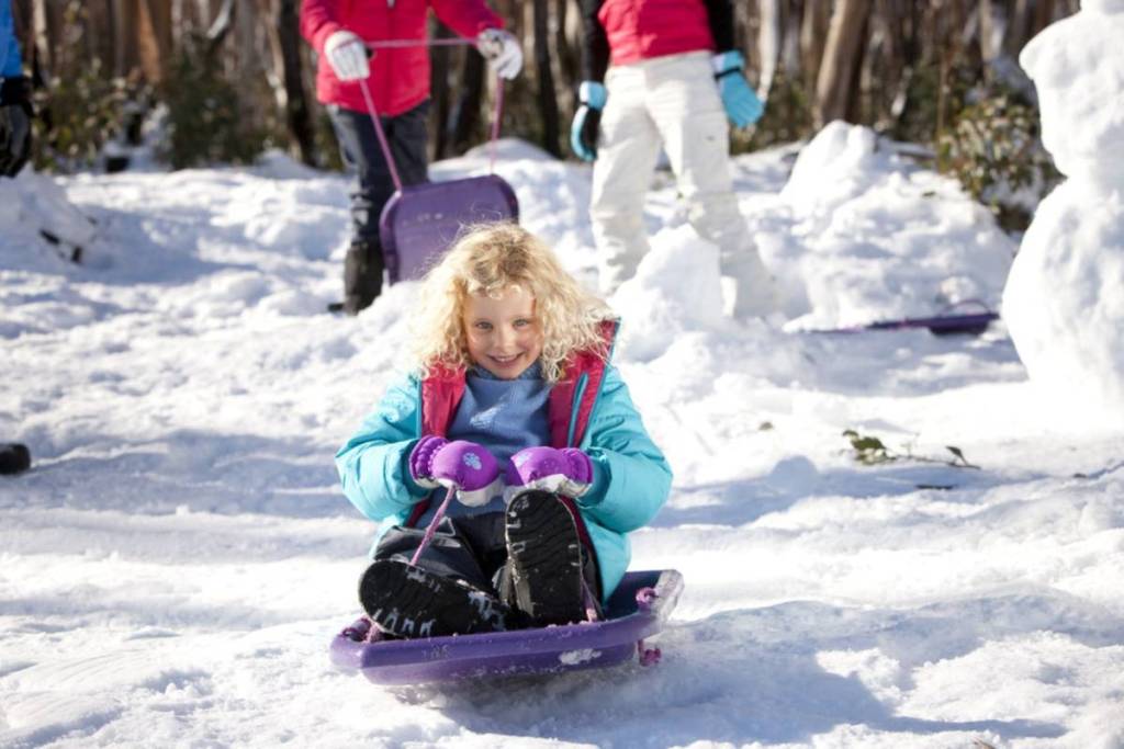 little girl riding the toboggan at Lake Mountain Alpine Resort