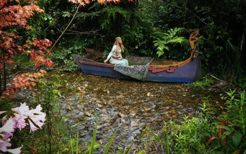 woman in the a boat by the creek at Brunos Art and Sculpture Garden in Marysville