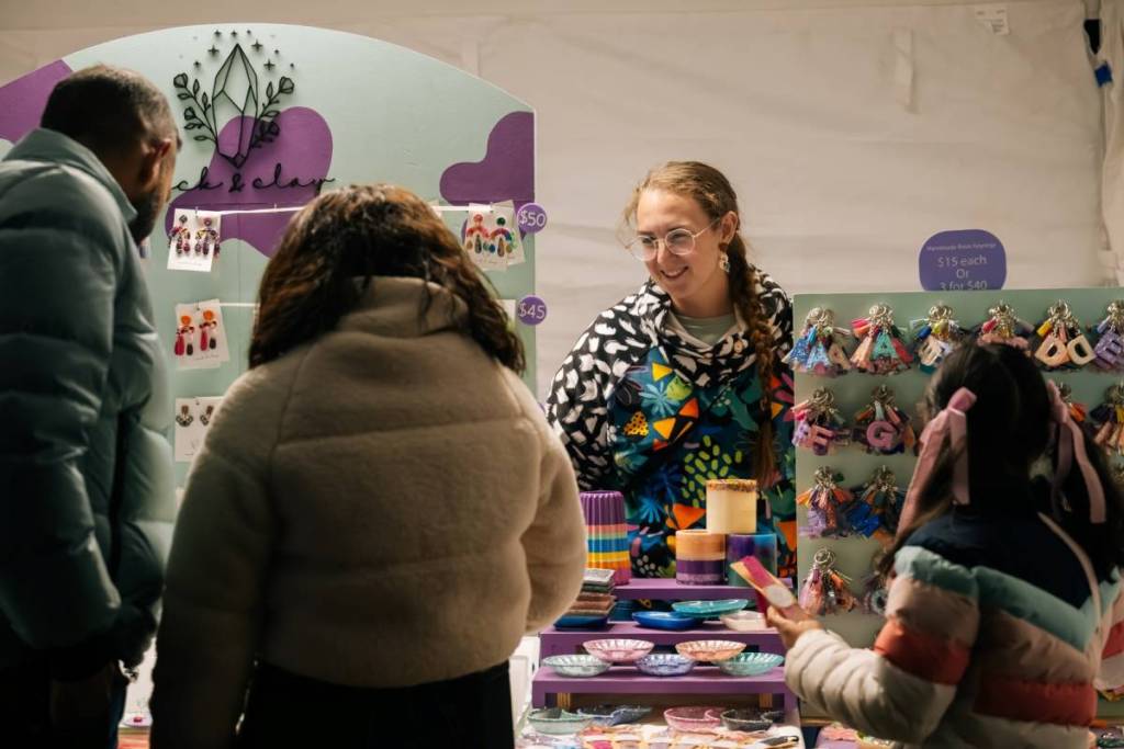 people browsing at a market stall at Firefly Night Market