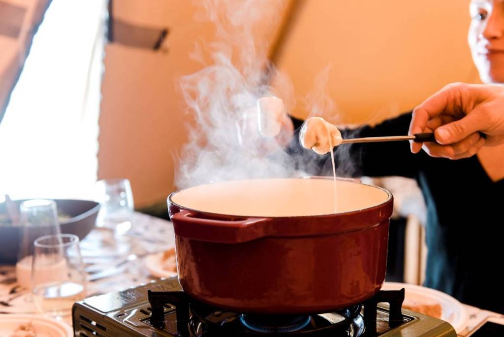 someone having fondue in the tipi at Alpine Nature Experience