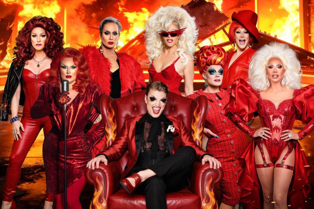 performers from Drag Roast wearing red in front of a fiery background
